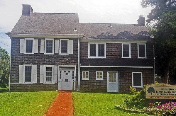 The brick Hopkins House on South Park Drive, behind a front lawn and a brick walk.
