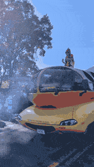 The Wienermobile rolls down the Bethlehem Halloween parade route with a hot dog mascot on top