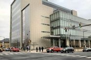 The Lehigh County Courthouse in Allentown, a glass and stone building at a street corner