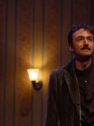 A Tales from Poe actor on a dim Hedgerow stage