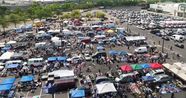 Aerial view of rows of vendor tents filling the Franklin Mills flea market lot